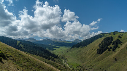 Fototapeta premium Time lapse of clouds over the mountains. Sky clouds over the mountains. Fast moving clouds forming beautiful shapes rolling over the peaks. Clouds over mountain range.