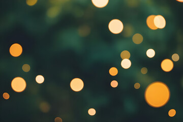 Fototapeta premium Golden bokeh lights creating a festive, sparkling background on dark green