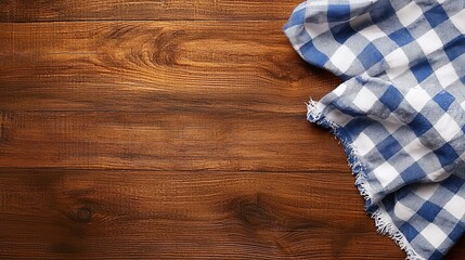 A blue and white checkered table cloth on a wooden table
