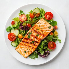 Grilled salmon fish fillet and fresh vegetable salad. Healthy keto food - green salad and roasted salmon steak on white background, top view, copy space. Barbecue meal. 