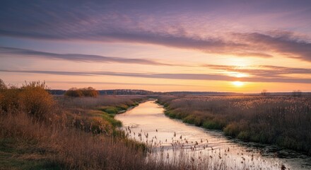 Fototapeta premium Scenic river landscape at sunset with lush vegetation and vibrant sky