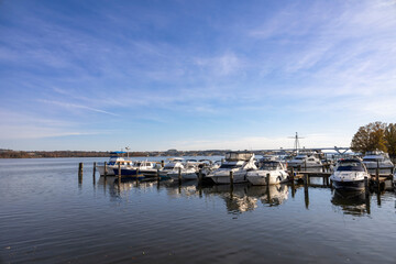 Fototapeta premium Picturesque view of Alexandria Marina beside the ferry dock from Washington, DC, featuring boats and serene waterfront surroundings.