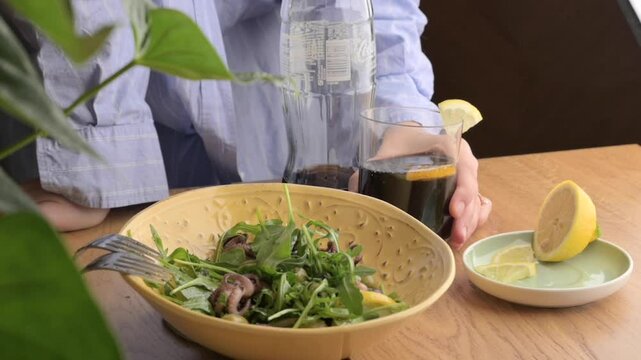 Fresh Octopus Salad with Herbs and Vinaigrette Mediterranean Culinary Delight. A vibrant Mediterranean-style octopus salad, prepared with fresh herbs, greens, and a zesty vinaigrette dressing