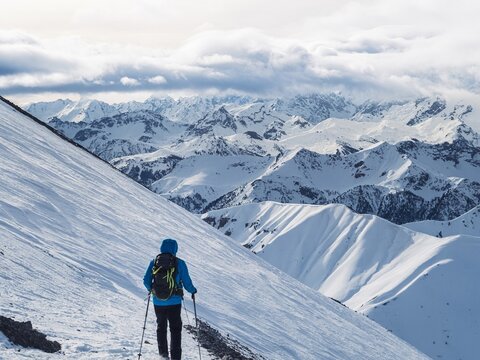 Hiker trekking in snowy mountain landscape