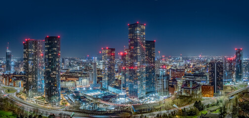 Fototapeta premium Manchester City Centre Aerial View at Night. Illuminated Skyline and Urban Architecture create vibrant England cityscape.