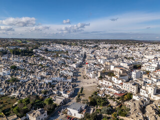 Aerial drone view of the old town center in Alberobello with many trulli houses.
