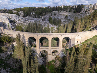 Aerial drone photo of the old Roman bridge in the town named Gravina in Puglia in southern Italy.