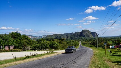 beautiful surroundings of Vi&ntilde;ales on cuba with a  car on the road 