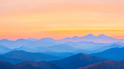 Mountain ridge bathed in warm sunset tones with distant peaks glowing softly