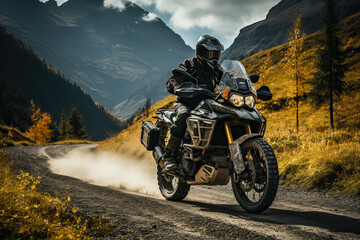 Obraz premium A motorcyclist, wearing protective gear, navigates a winding mountain road on a powerful adventure bike. The autumnal landscape is breathtaking.