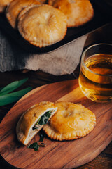 Freshly Baked Hand Pies Filled with Blue Chives and Mushrooms and Sliced One Pie