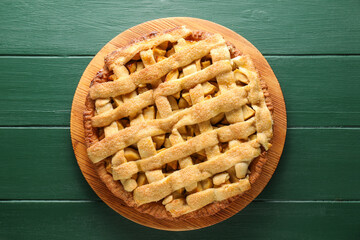 Tasty homemade apple pie on green wooden table, top view