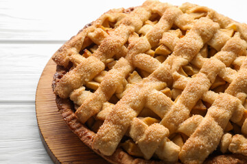 Tasty homemade apple pie on white wooden table, closeup