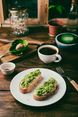 Avocado toasts and coffee on rustic table