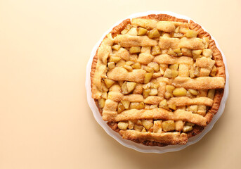 Tasty homemade apple pie on beige background, top view. Space for text