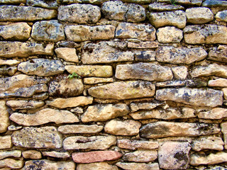 Ancient limestone wall found in a street in St Leon sur Vezere
