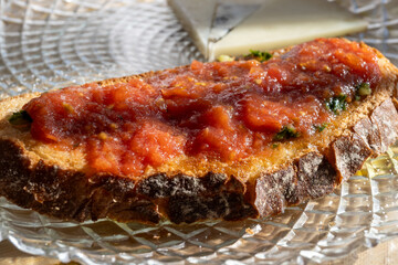 Traditional andalusian breakfast on roof patio with bread toasts, fresh ground tomatoes sauce and olive oil, Sevilla, Andalusia, Spain.