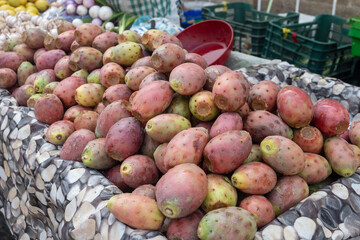 Ripe juicy edible fruits opuntia prickly pears cacti for sale on Triana farmer market in Sevilla, Andalusia, Spain