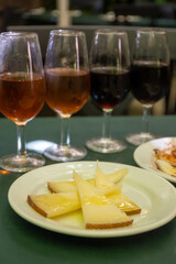 Tasting of Spanish sherry wine and cheeses, manchego curado cheese on white board