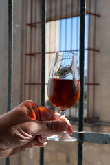 Hand with glass of sherry fino, manzanilla, wine, jerez fortified wine from palomino white grape...