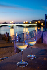 Two glasses of cold dry white wine served outdoor in cafe at night in historical Triana district, Sevilla, Spain, close up