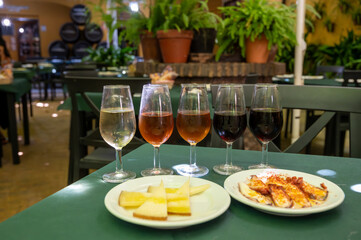 Tasting of sherry wines from barrels, fino, manzanilla, olorosso, amontillado jerez wines with traditional Andalusian tapas in old tavern, Sanlucar de Barrameda, Cadiz, Andalusia, Spain