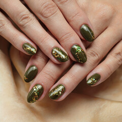 hand model glittery olive green manicured polished fingernails healthy skin fingers or salon treatment