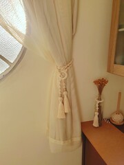 Macramé curtain holder.