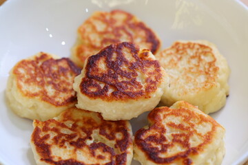 Deliciously made Golden Potato Pancakes beautifully arranged on a pristine White Plate