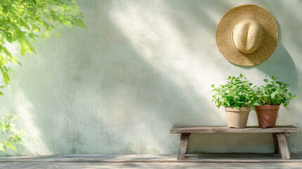 Potted plants and straw hat hanging on a rustic wall in a gardening corner with wooden elements, creating a cozy and relaxing atmosphere