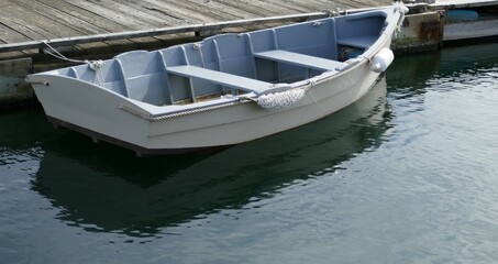 Obraz premium adventure, anchored, boat, boats, calm, coast, coastal, coastal lifestyle, dinghy, docked, empty boat, fishing, fishing boat, fishing harbor, harbor, imagination, jetty, lake, leisure, marine, moored,