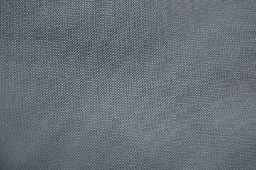Dense, synthetic, nylon material. Green, gray fabric, unusual background.