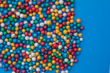 Colorful multicolored balls scattered against on bright blue background