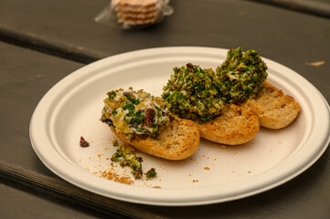 Savory crostini with vibrant toppings served on a rustic plate at a cozy outdoor gathering