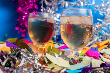 Two glasses of champagne with colorful party decorations, Closeup