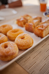 Sugar donuts in a row served on a plate