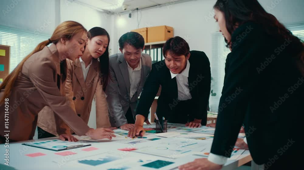 Poster asian entrepreneurs and managers gather around a table, examining charts and graphs, engaging in a c