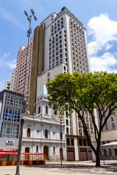 S&Atilde;O PAULO, SP, BRAZIL - OCTOBER 13, 2024: Facade of the Igreja de Santo Ant&ocirc;nio (Church of Saint Anthony) and the Othon Building in Pra&ccedil;a do Patriarca, the city's historic center.