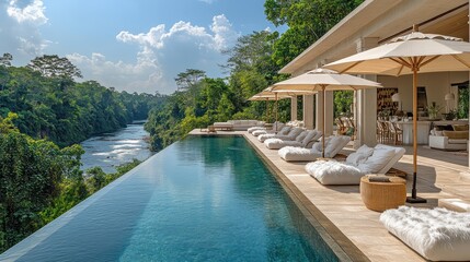 Infinity pool overlooking lush jungle river.