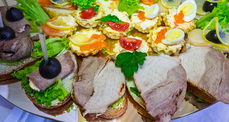 Gourmet appetizer platter with assorted sandwiches and hors d'oeuvres