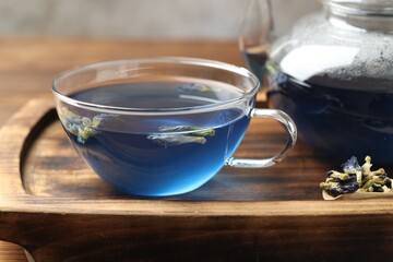 Delicious butterfly pea flower tea on wooden table, closeup