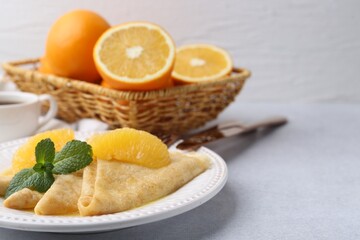 Delicious Crepes Suzette served on light table, closeup. Space for text