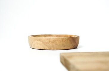 Small wooden plate is facing up. suitable for putting food products, bottles, and more. isolated on white background.