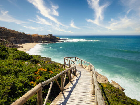 Beautiful landscape view of ocean coastline and wooden bridge, Ribeira d'Ilhas, Portugal