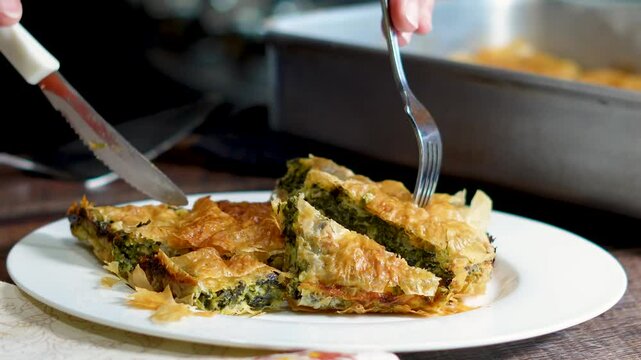 Making a Greek favorite, spinach pie with its richness of flavor with spinach, onions, feta cheese and all wrapped up in a flaky dough.  Spinach Pie ready for diner tonite.