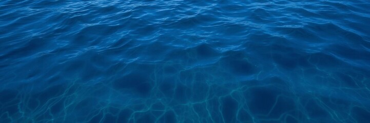 Textured deep blue sea surface with rippling waves and reflections of the sky above, marine, ocean, sea