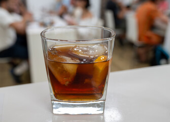 Tasting Sherry sweat cream wine on ice rocks, jerez fortified wine made from palomino white grape served in Jerez de la Frontera, Cadiz, Andalusia, Spain