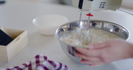 Woman Using Mixer and Mixing Pancake Batter in Bowl