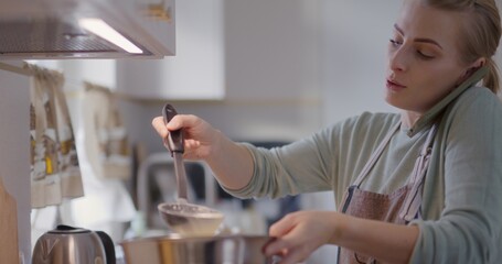 Busy Woman in Kitchen Talking on Phone While Preparing Food and Frying