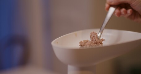 Refilling meat container in meat mincer during grinding process